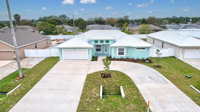 view of front of home with a front lawn and a garage