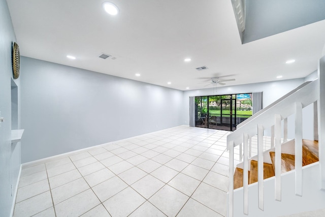 empty room featuring light tile patterned floors and ceiling fan