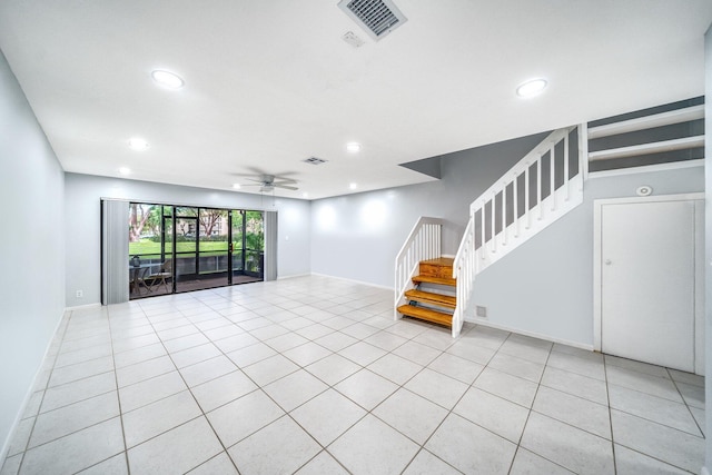 unfurnished living room featuring ceiling fan and light tile patterned floors