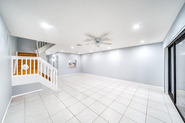 tiled spare room featuring ceiling fan