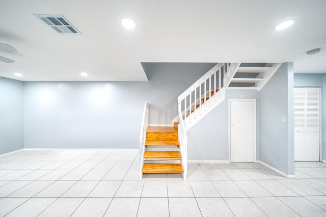 stairway featuring tile patterned flooring