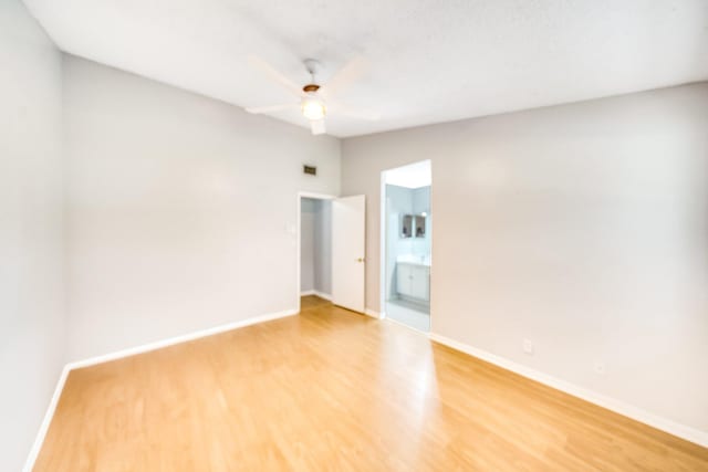 unfurnished room with ceiling fan and hardwood / wood-style flooring