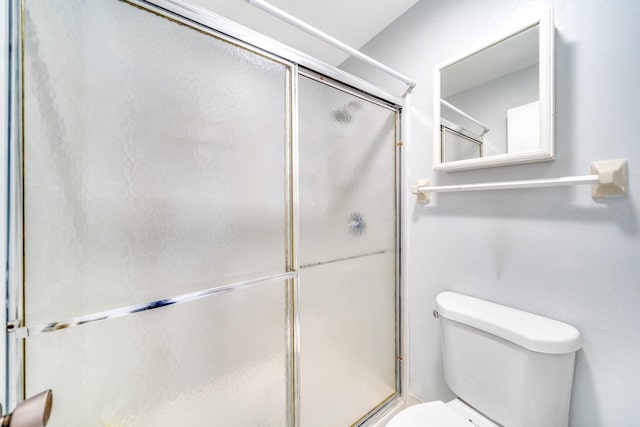 bathroom with toilet and walk in shower