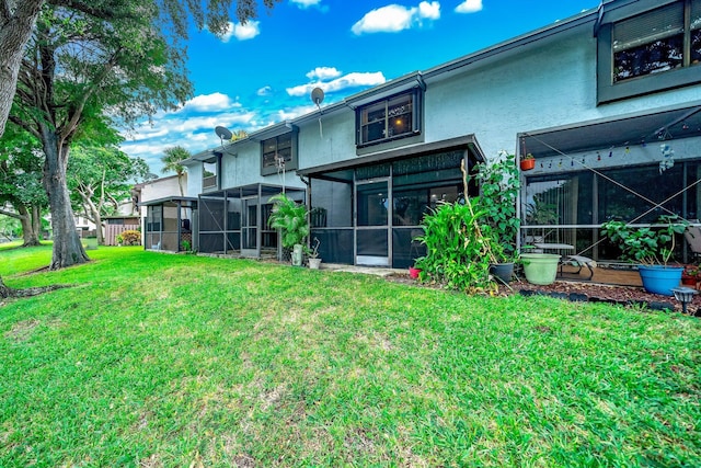 rear view of house featuring a yard