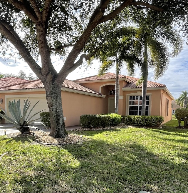 view of front of home with a front yard and a garage