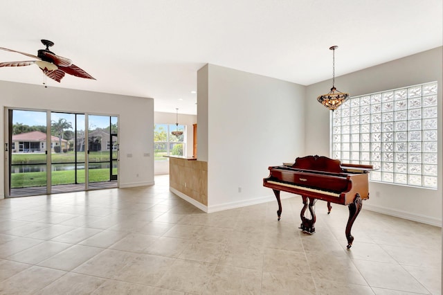 10623 Silverton Ln, Boynton Beach, FL 33437 - living area with a chandelier, baseboards, and light tile patterned floors