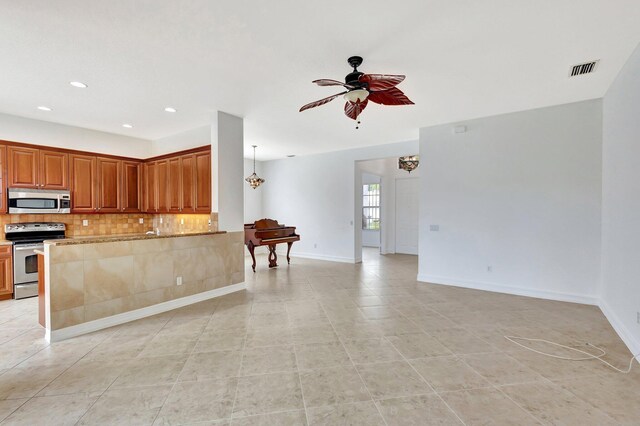 unfurnished living room with ceiling fan and light tile patterned floors