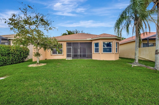 10623 Silverton Ln, Boynton Beach, FL 33437 - rear view of house featuring a tiled roof, stucco siding, a sunroom, and a yard