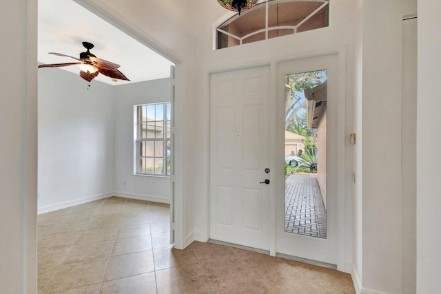 10623 Silverton Ln, Boynton Beach, FL 33437 - foyer entrance with light tile patterned floors, ceiling fan, and baseboards