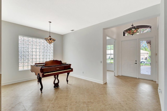10623 Silverton Ln, Boynton Beach, FL 33437 - foyer entrance featuring a chandelier, baseboards, and light tile patterned flooring