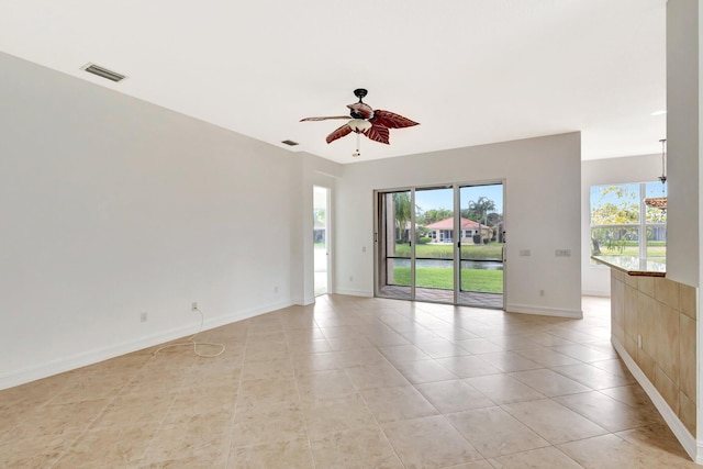 10623 Silverton Ln, Boynton Beach, FL 33437 - spare room featuring a ceiling fan, light tile patterned flooring, baseboards, and a water view