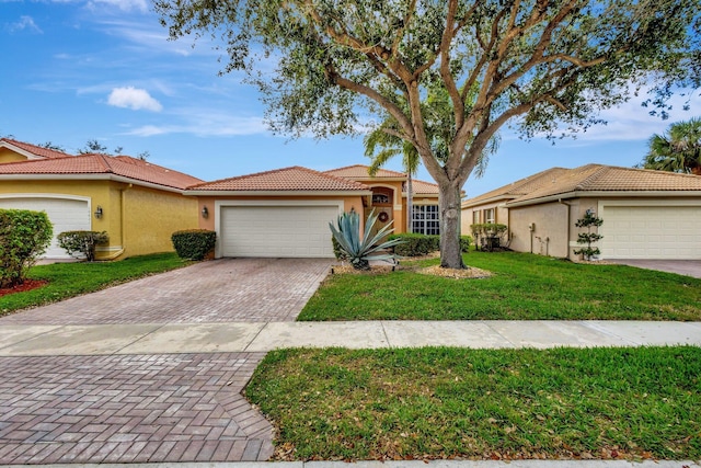 ranch-style home with a garage and a front yard