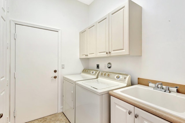 10623 Silverton Ln, Boynton Beach, FL 33437 - clothes washing area with cabinet space, washing machine and clothes dryer, and light tile patterned floors