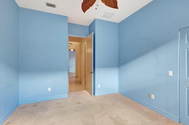 additional living space with light carpet and ceiling fan