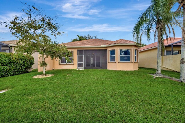 single story home with a garage and a front lawn