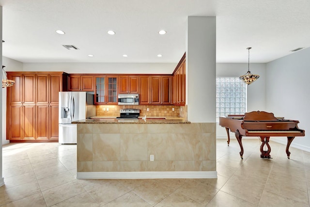 10623 Silverton Ln, Boynton Beach, FL 33437 - kitchen featuring stainless steel appliances, recessed lighting, tasteful backsplash, stone countertops, and glass insert cabinets