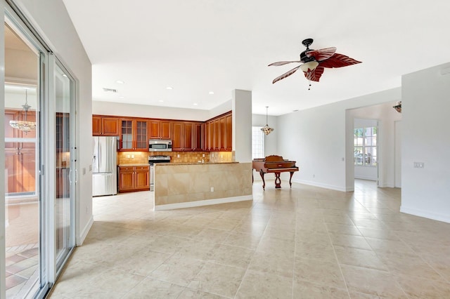 10623 Silverton Ln, Boynton Beach, FL 33437 - kitchen featuring appliances with stainless steel finishes, a chandelier, light tile patterned floors, backsplash, and recessed lighting