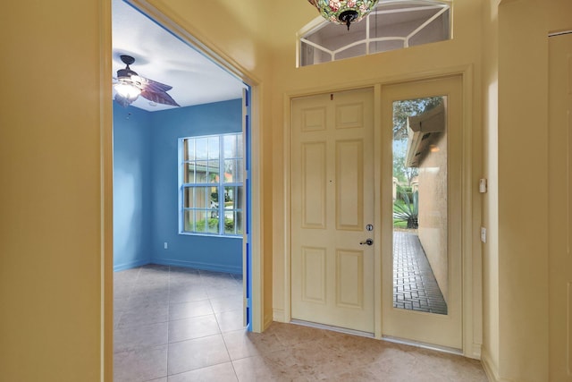 tiled entryway featuring ceiling fan