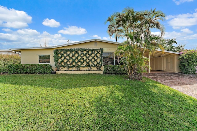 exterior space with a carport and a front yard