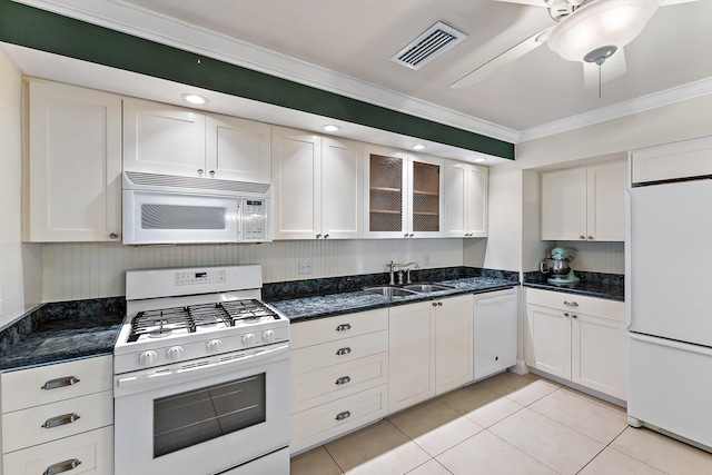 kitchen with white appliances, white cabinets, crown molding, sink, and light tile patterned floors