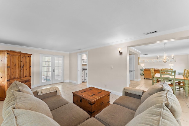 living room with a notable chandelier, light tile patterned floors, and crown molding