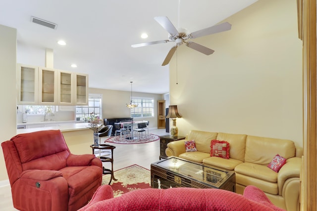 living room featuring ceiling fan and light hardwood / wood-style flooring