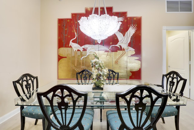 dining space featuring an inviting chandelier and wood-type flooring