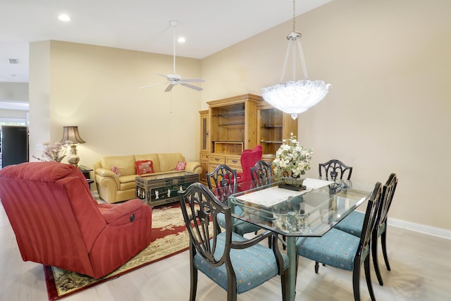 dining area with ceiling fan and a high ceiling