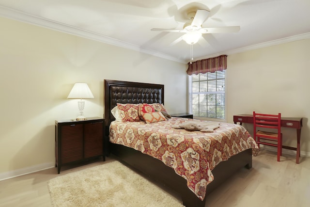 bedroom featuring crown molding, light hardwood / wood-style floors, and ceiling fan