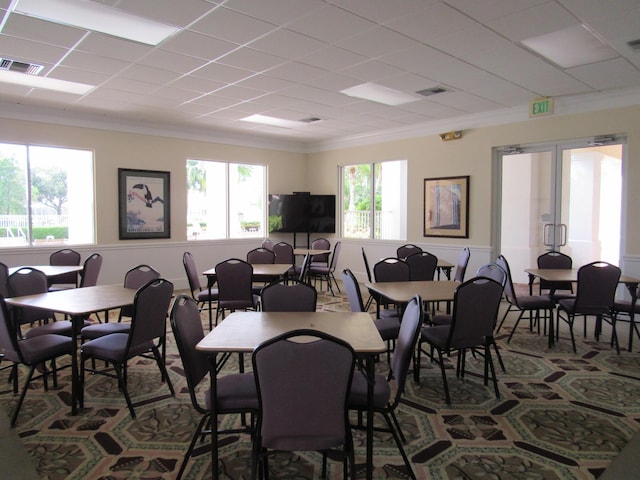 dining space featuring crown molding