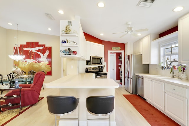 kitchen with white cabinetry, stainless steel appliances, and sink