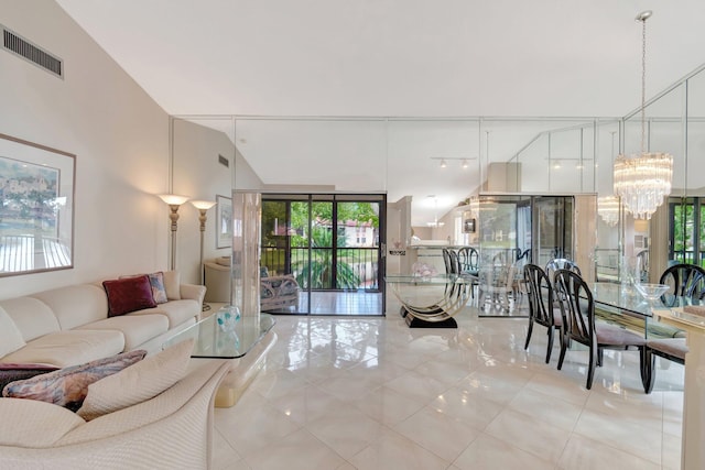 living room featuring expansive windows and a notable chandelier