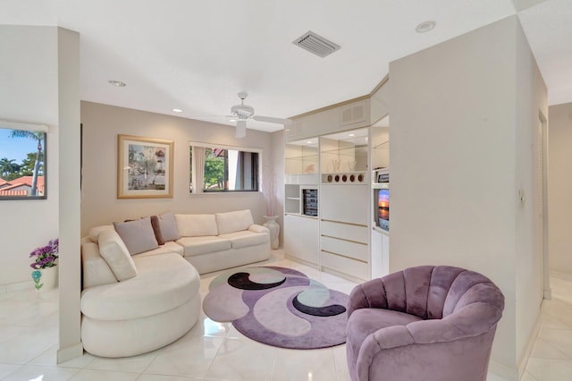 tiled living room featuring built in features and ceiling fan