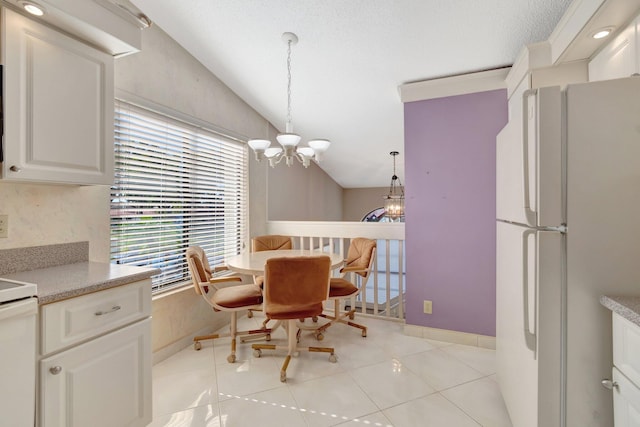 dining area featuring a notable chandelier, light tile patterned floors, and vaulted ceiling