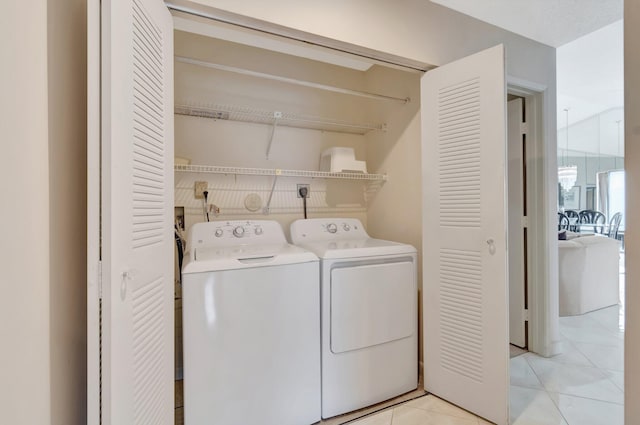 washroom with light tile patterned flooring and washing machine and dryer