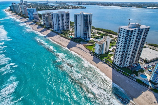 drone / aerial view featuring a water view and a beach view