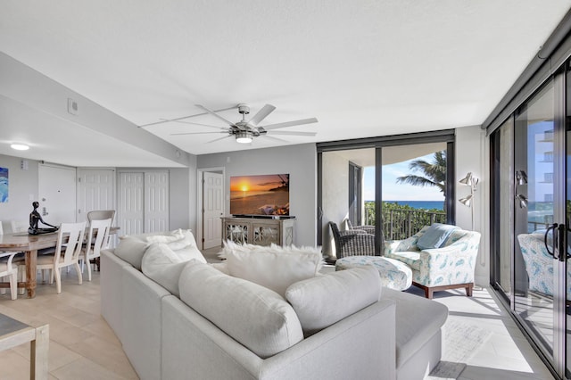 living room with ceiling fan and floor to ceiling windows