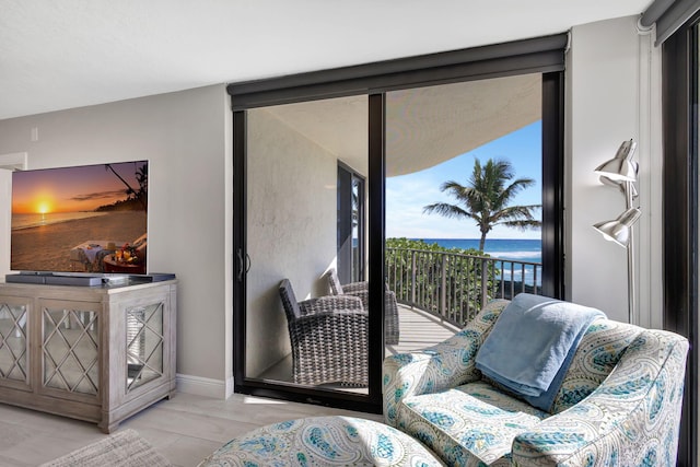 living area with a healthy amount of sunlight and a water view