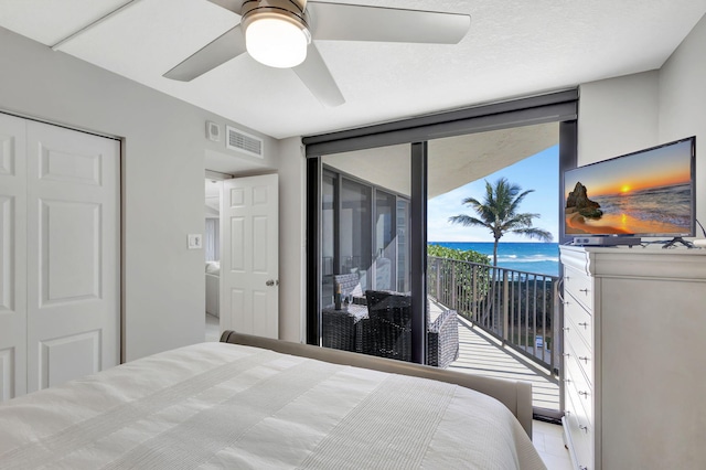 bedroom featuring access to outside, ceiling fan, and a closet