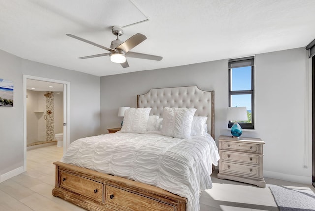 bedroom with ensuite bathroom, light hardwood / wood-style flooring, and ceiling fan