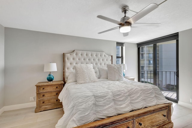 bedroom with access to exterior, light hardwood / wood-style flooring, multiple windows, and ceiling fan