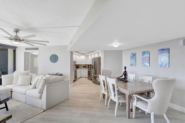 dining space featuring ceiling fan and light wood-type flooring