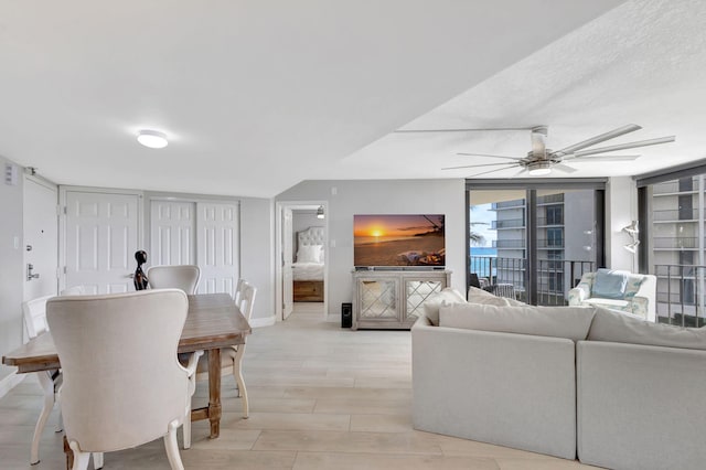 living room with ceiling fan and light wood-type flooring