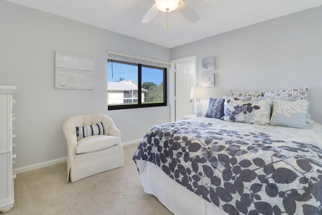 bedroom featuring light colored carpet and ceiling fan