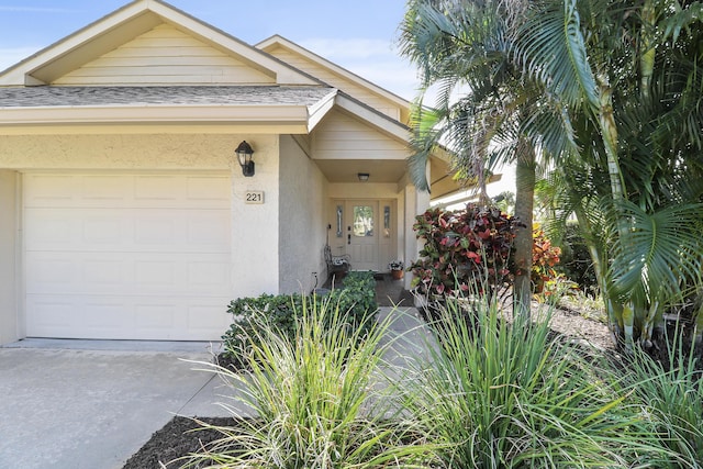 view of exterior entry with a garage