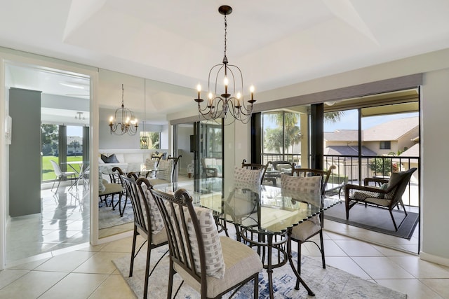 tiled dining room with a raised ceiling and a notable chandelier