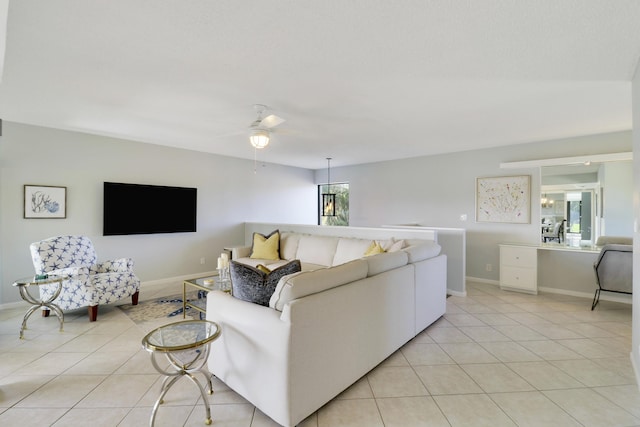 living room featuring ceiling fan and light tile patterned flooring