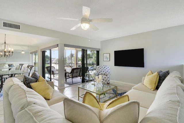 living room with ceiling fan with notable chandelier and light tile patterned floors