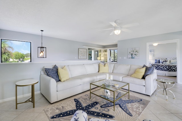 living room with ceiling fan and light tile patterned floors