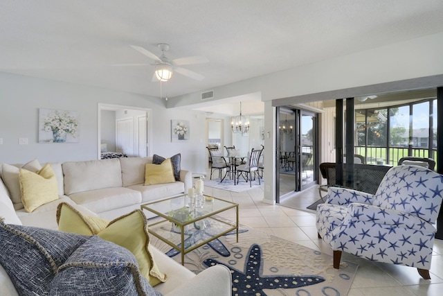 living room with light tile patterned floors and ceiling fan with notable chandelier